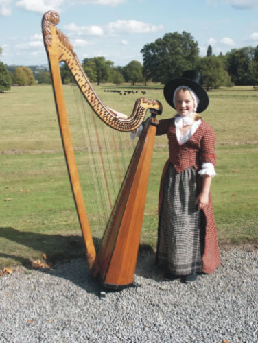 Photograph of Lady Llanover's Great-Great-Great-Great Grand-Daughter wearing her ancestors original costume with a Llanover Triple Harp.